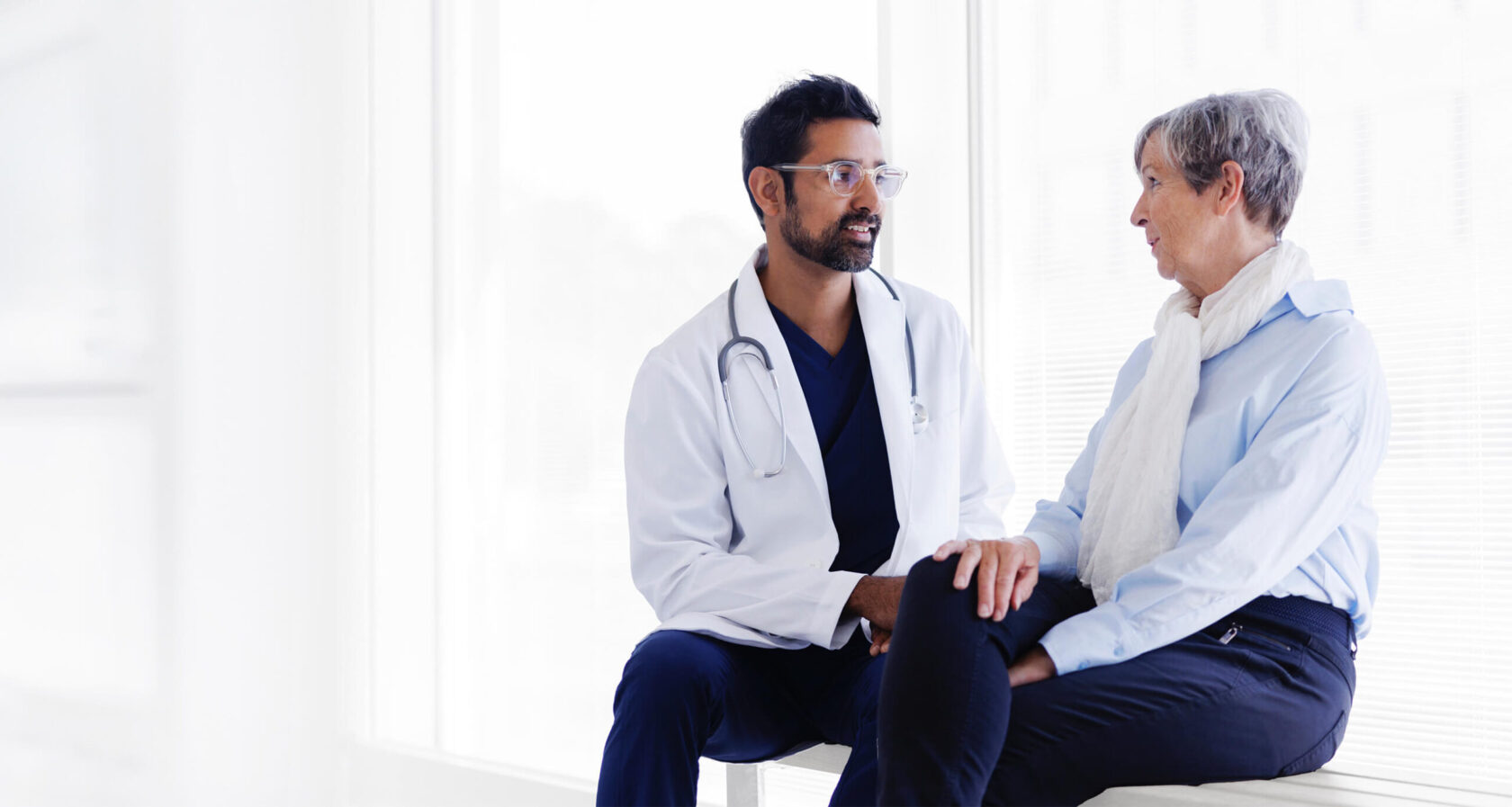 Female patient and male doctor discuss.